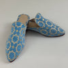 Pair of blue patterned shoes on a light gray background
