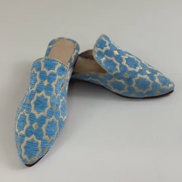 Pair of blue patterned shoes on a light gray background