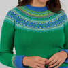 Person wearing a green Eribe sweater with blue and multicolor pattern on a gray background