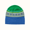 Knitted Eribe beanie with green top and blue bottom, featuring a colorful pattern on the band, on a white background.