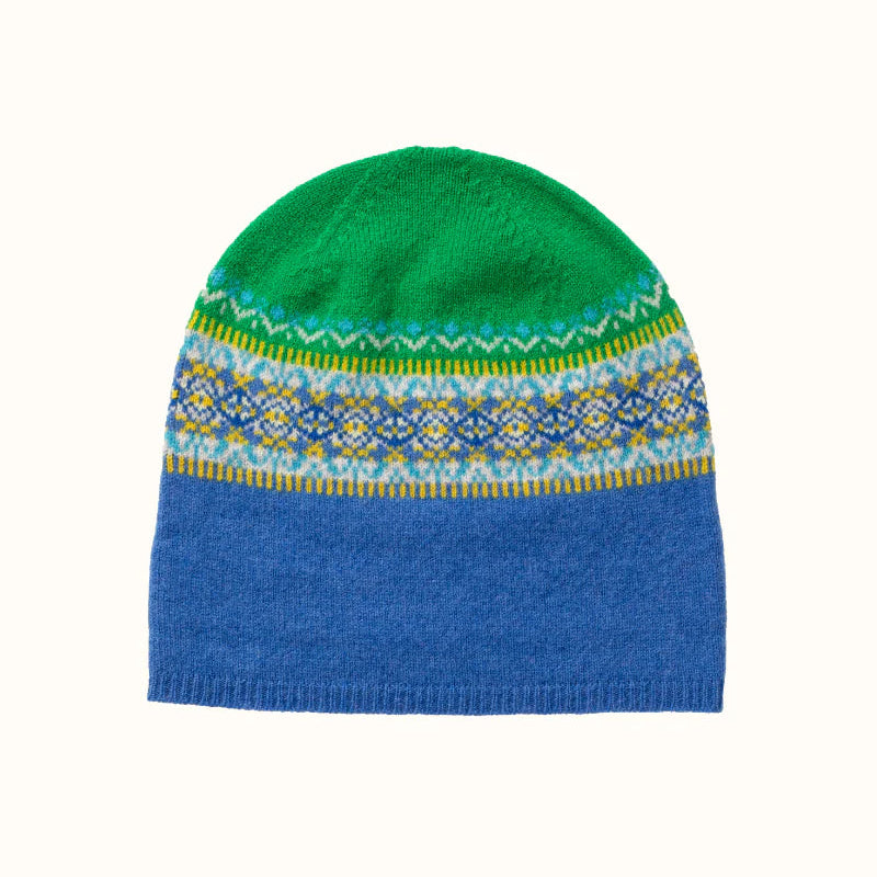 Knitted Eribe beanie with green top and blue bottom, featuring a colorful pattern on the band, on a white background.