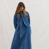 Woman wearing a Binny denim dress with a matching scarf against a white background