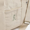 Beige backpack with a logo on a white background