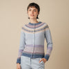 Woman wearing an Eribe cardigan against a beige background