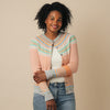 Woman wearing an Eribe cardigan with a beige background