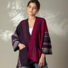 Woman wearing a colorful Eribe kimono-style cardigan against a neutral background