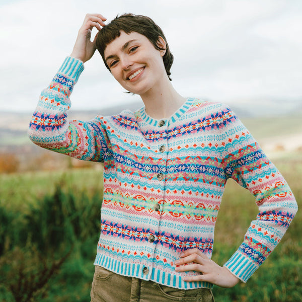Person wearing a colorful patterned Eribe cardigan standing outdoors with a blurred background