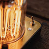 Close-up of a vintage-style light bulb on a wooden surface