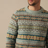 Man wearing a patterned Eribe sweater with a neutral background