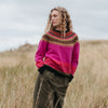 Person wearing a Eribe sweater standing in a grassy field