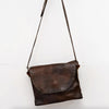 Brown leather shoulder bag on a white background
