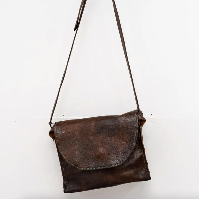 Brown leather shoulder bag on a white background