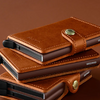 Stack of brown leather card holders on a brown background