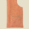 Orange sleeveless garment with a pocket on a beige background