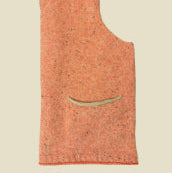 Orange sleeveless garment with a pocket on a beige background