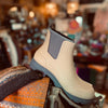 Stone Merry People Oberon boot with grey sole on a blurred background of a store.