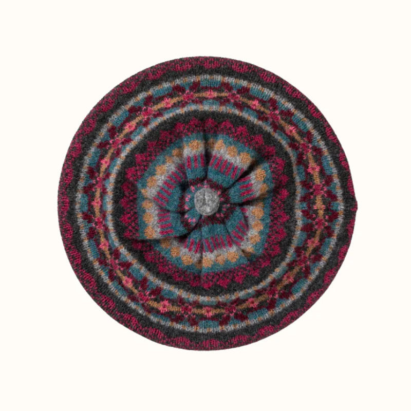 Multicolored circular woven woollen beret  on a white background