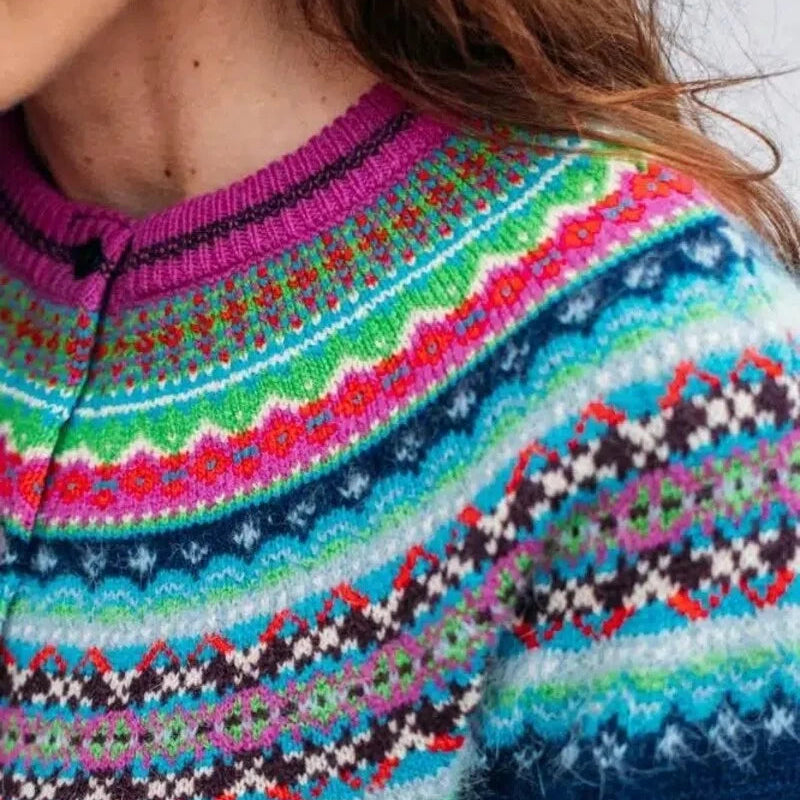 Close-up of a colorful Eribe cardigan with a blue background